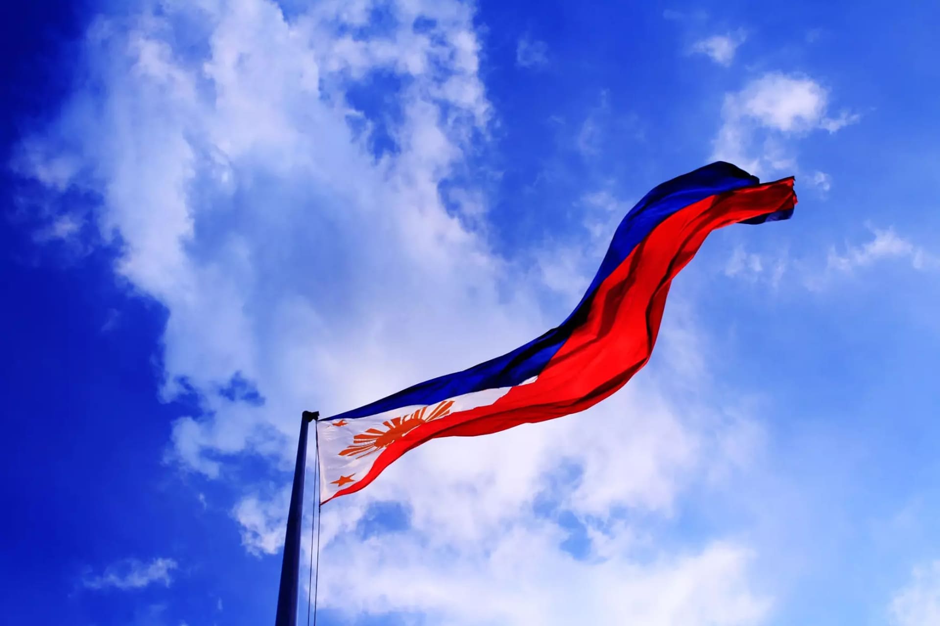 A Filipino flag flapping in the wind.