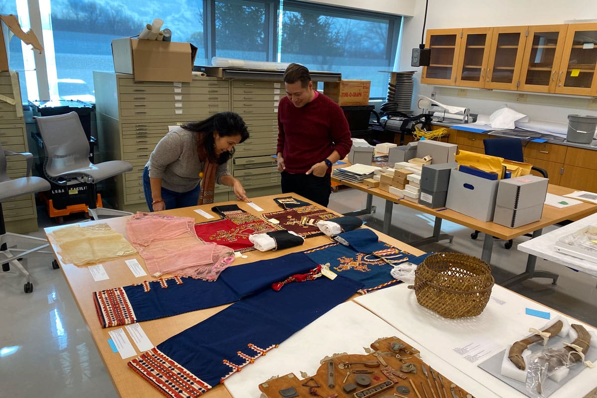 Two people looking at artifacts in a laboratory.