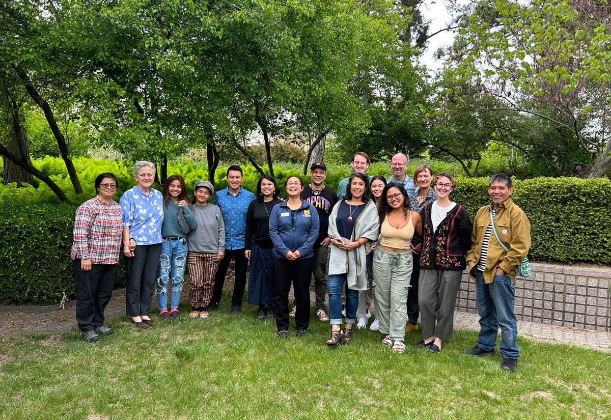 A group of people posing for a photo outdoors.