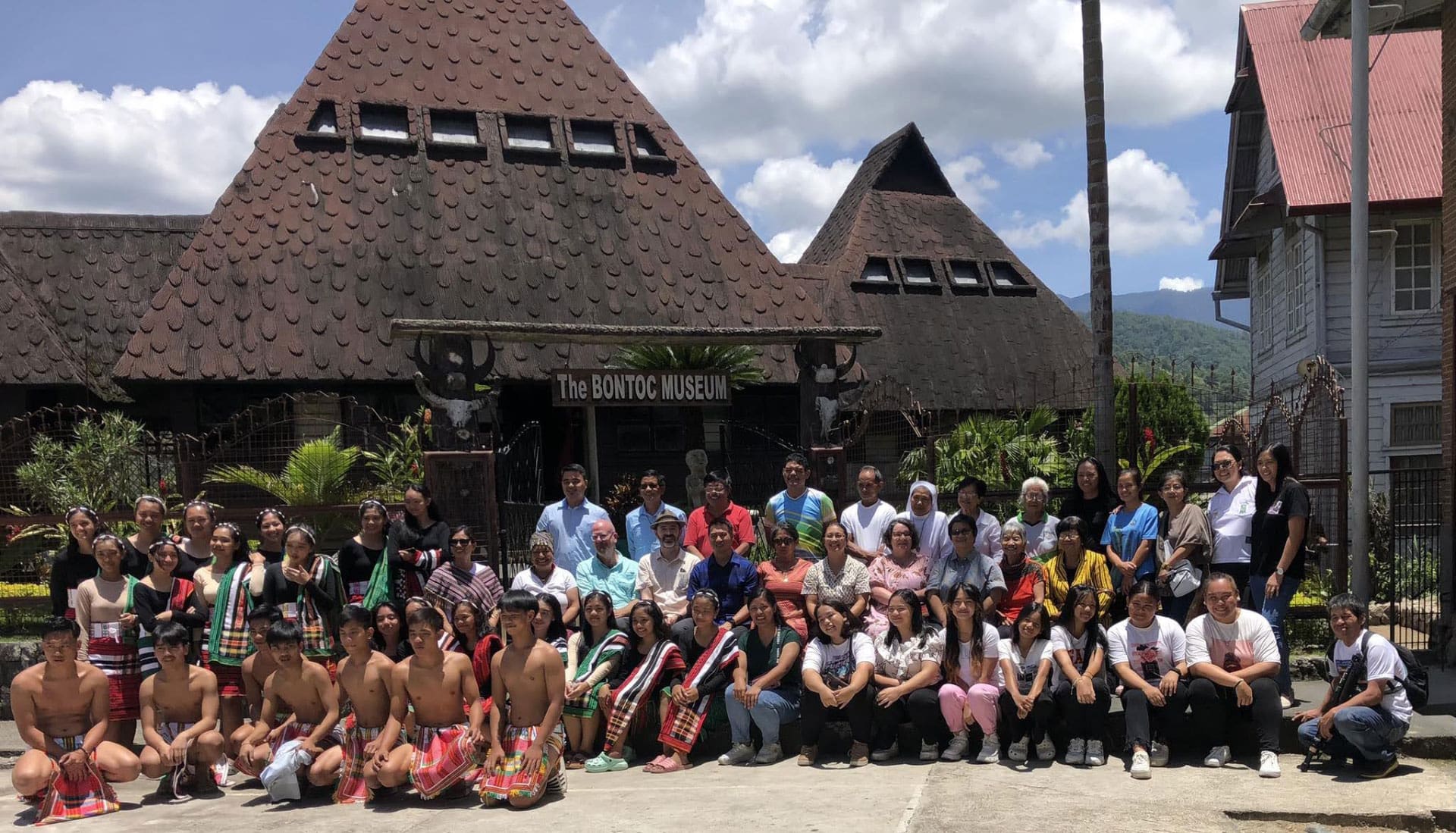 A large group photo outside of a museum in the Philippines