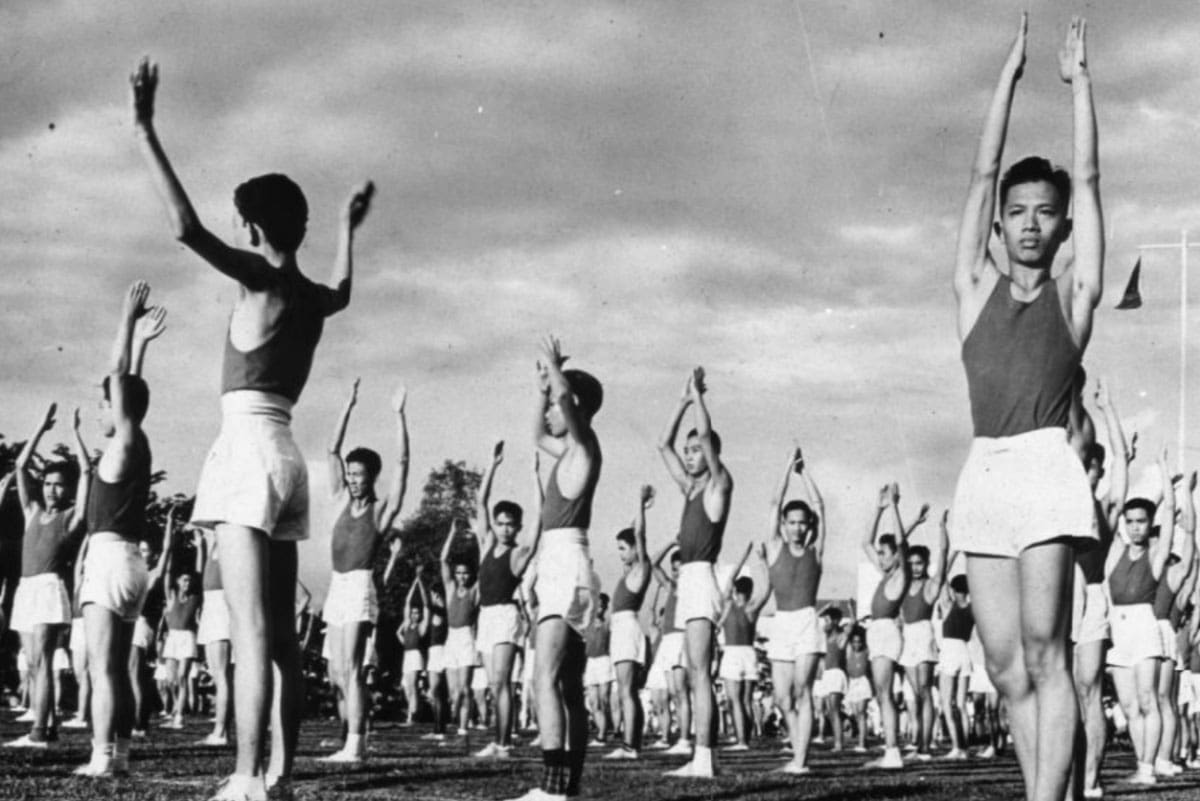A group of young men doing exercises outdoors