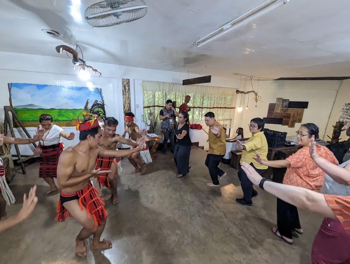 A group of people doing an indigenous dance.