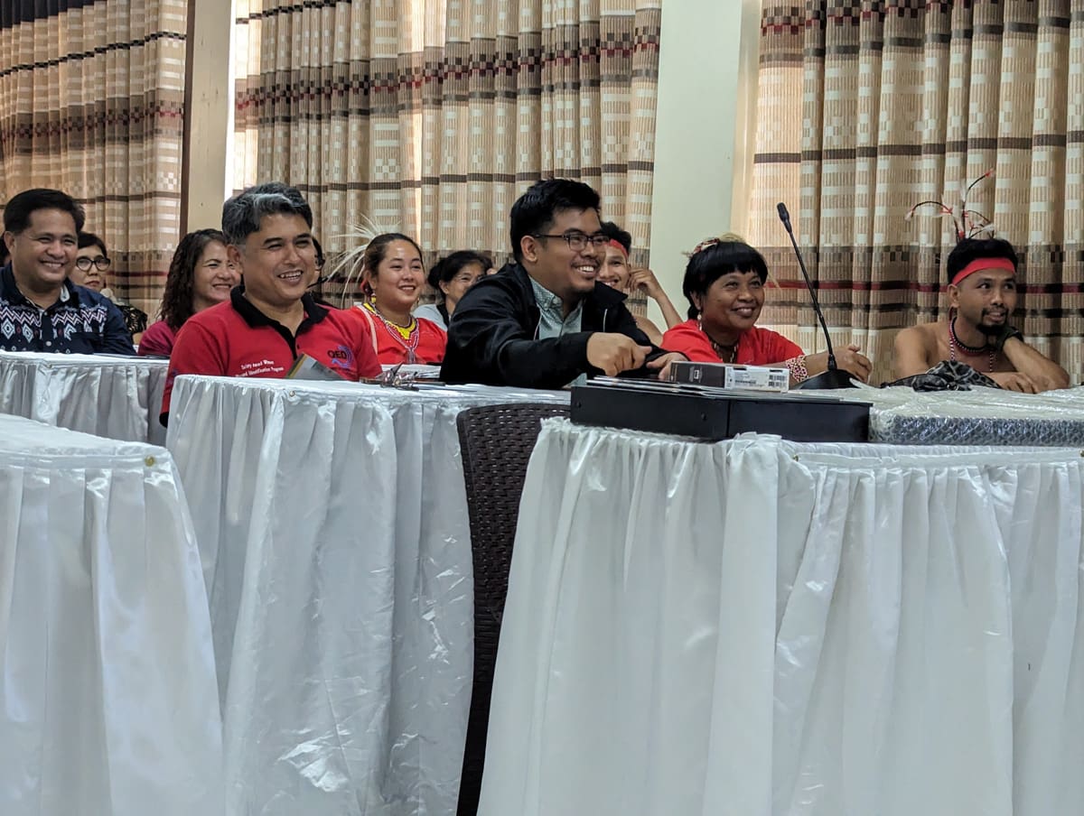 A group of people seated at a table smiling.