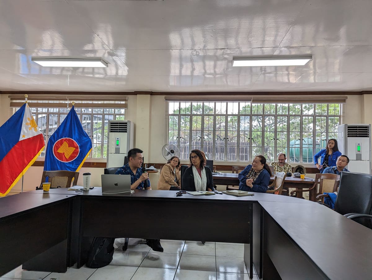 People giving a presentation in a conference room.