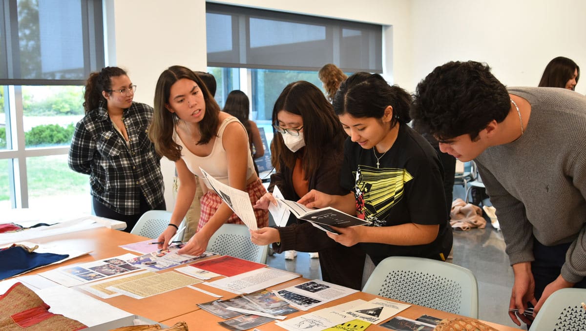 A group of students looking at archival materials