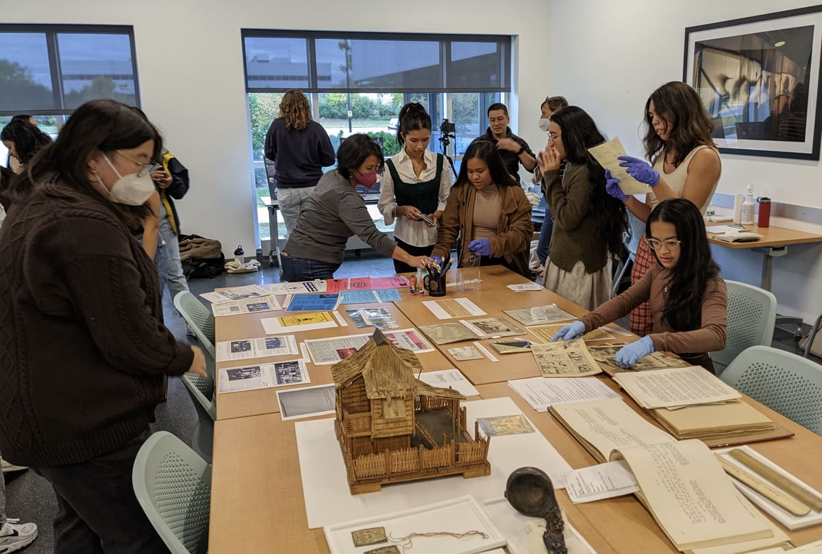 A group of students looking at archival materials