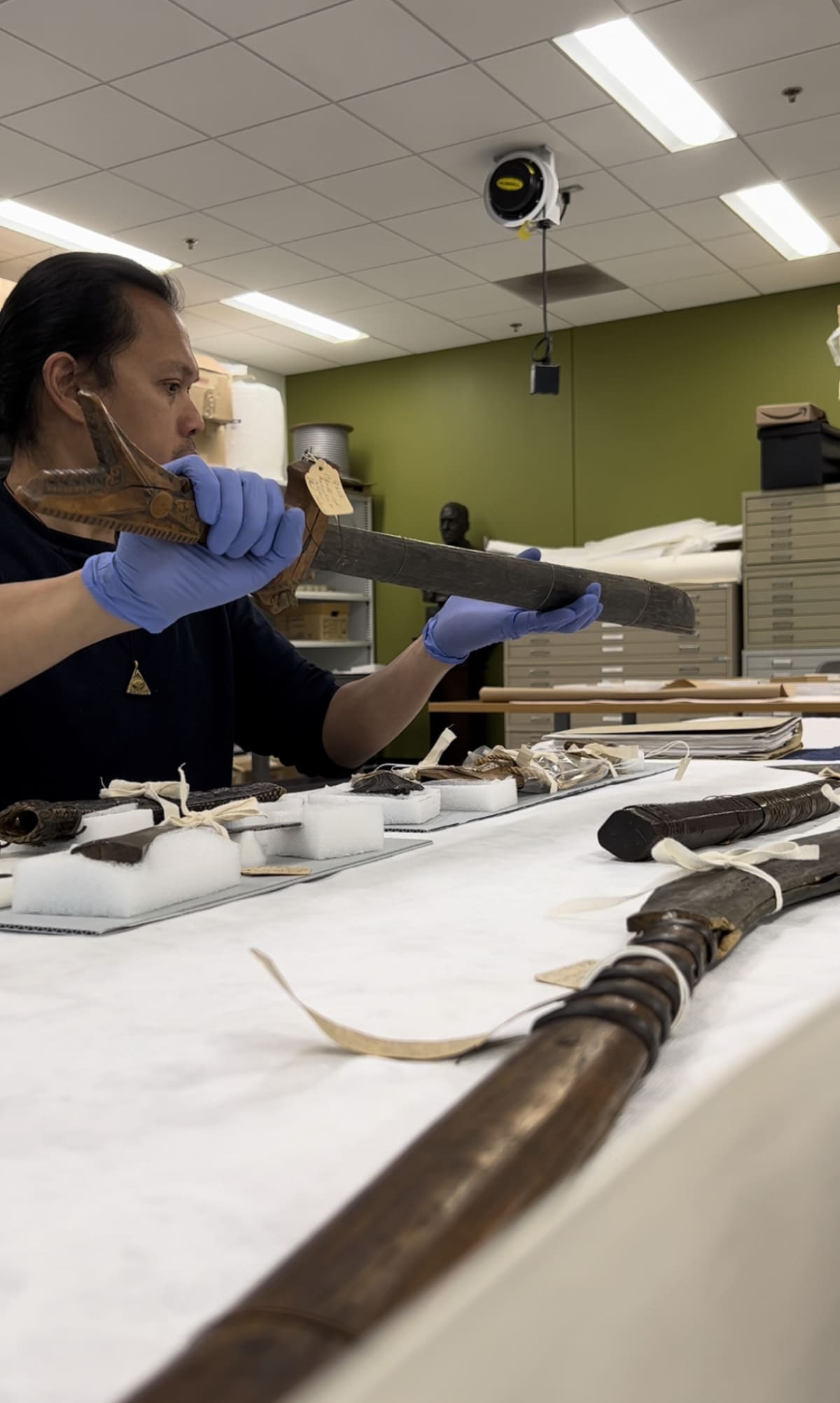 A man examining a bladed weapon.