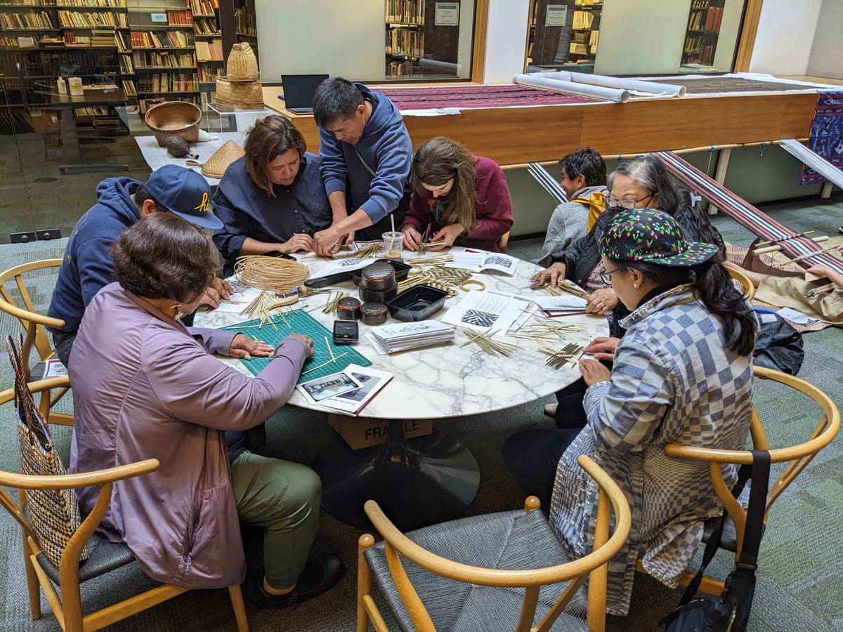 A mean leading a workshop on basket weaving.