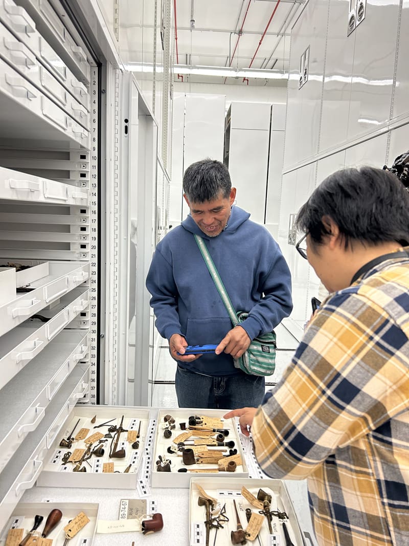 A man looking at a drawer of tools.